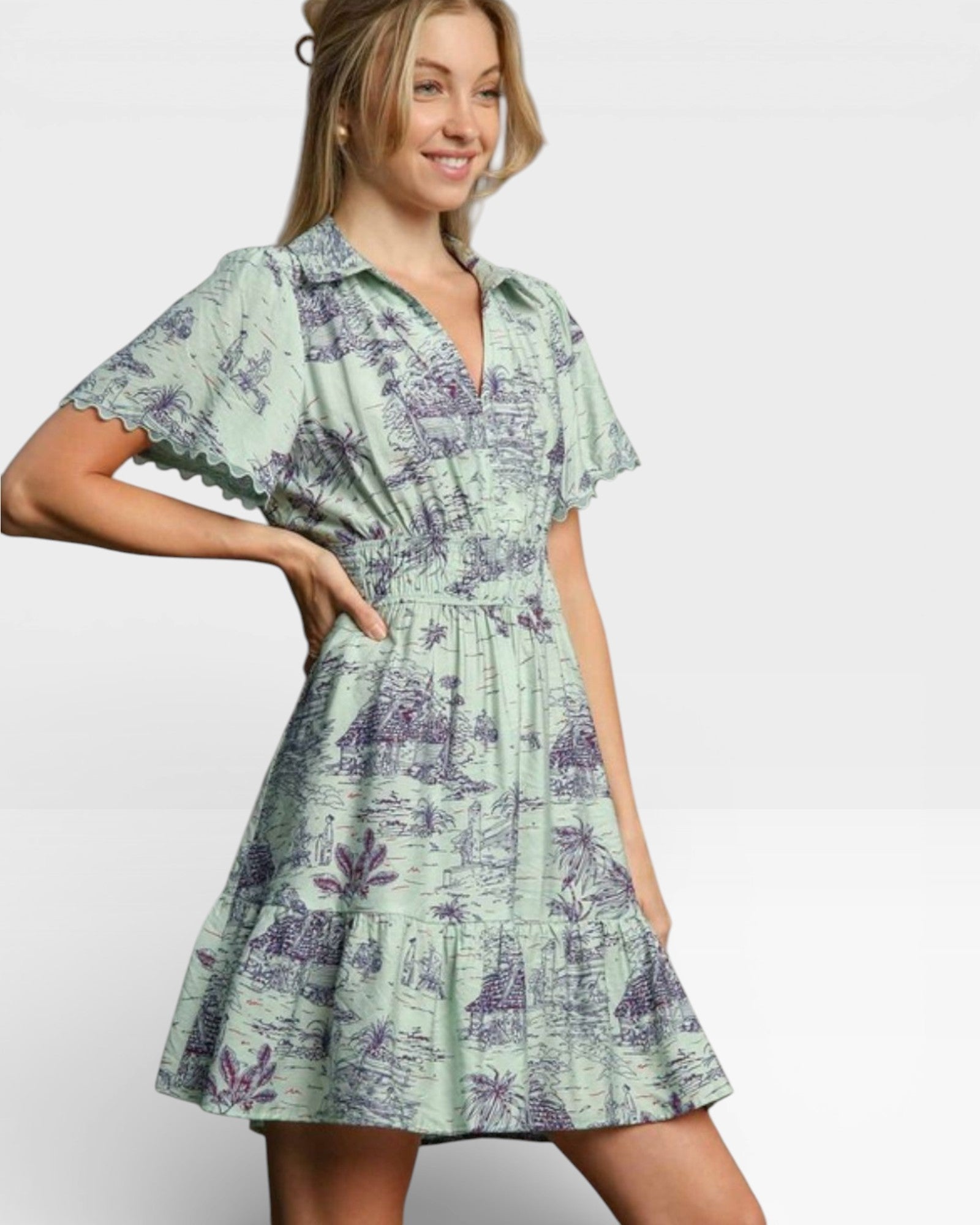 Woman wearing a green floral dress on a plain background