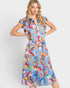 Woman wearing a colorful floral dress on a white background