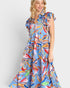 Woman wearing a colorful floral dress on a white background