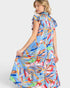 Woman wearing a colorful floral dress on a white background