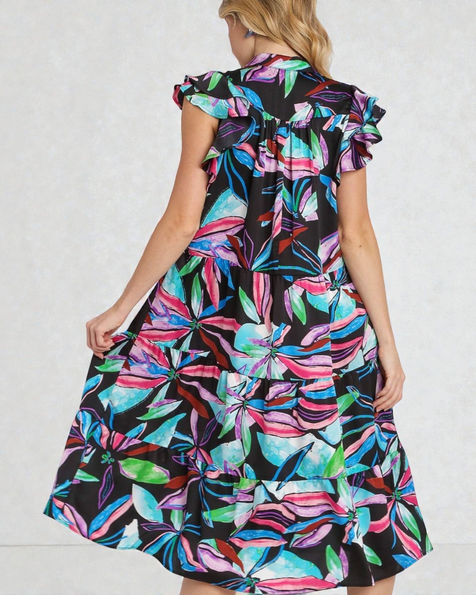 Woman wearing a colorful floral dress on a white background