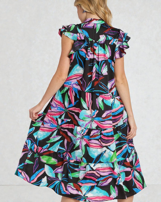 Woman wearing a colorful floral dress on a white background