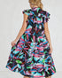 Woman wearing a colorful floral dress on a white background