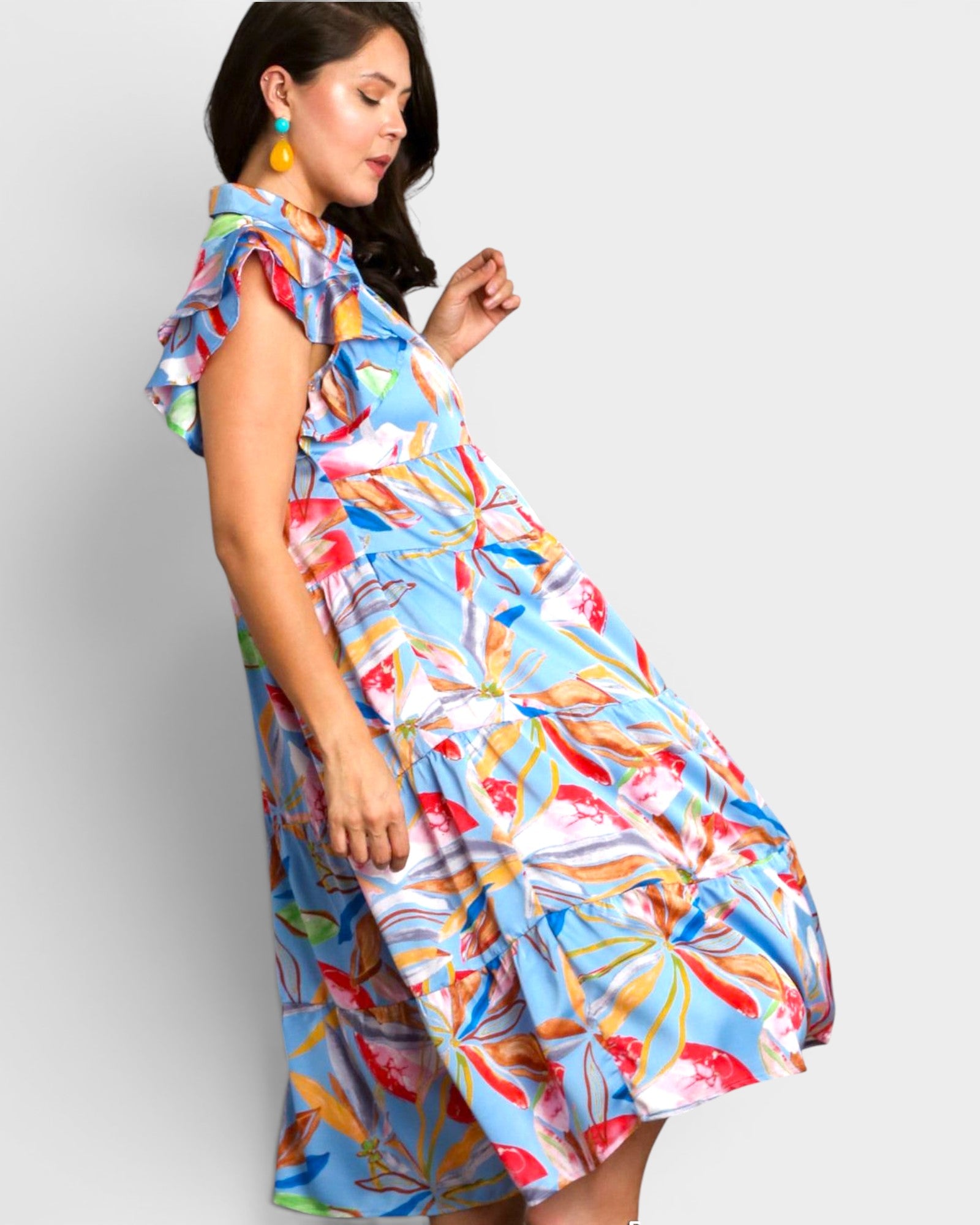 Woman wearing a colorful dress with a white background