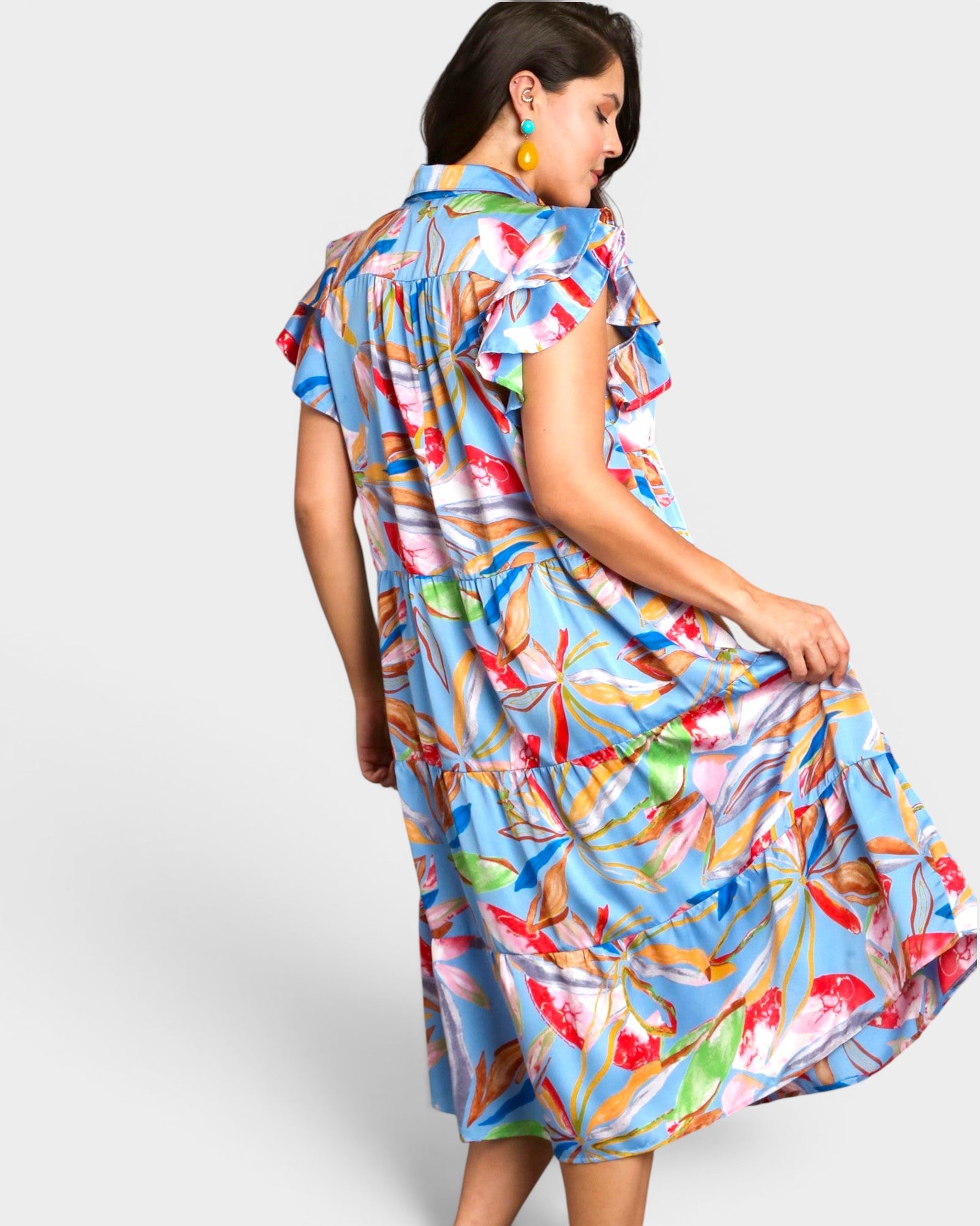 Woman wearing a colorful dress with a white background