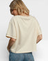 Person wearing a beige t-shirt and blue jeans on a white background