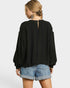 Person wearing a black top and denim shorts on a white background