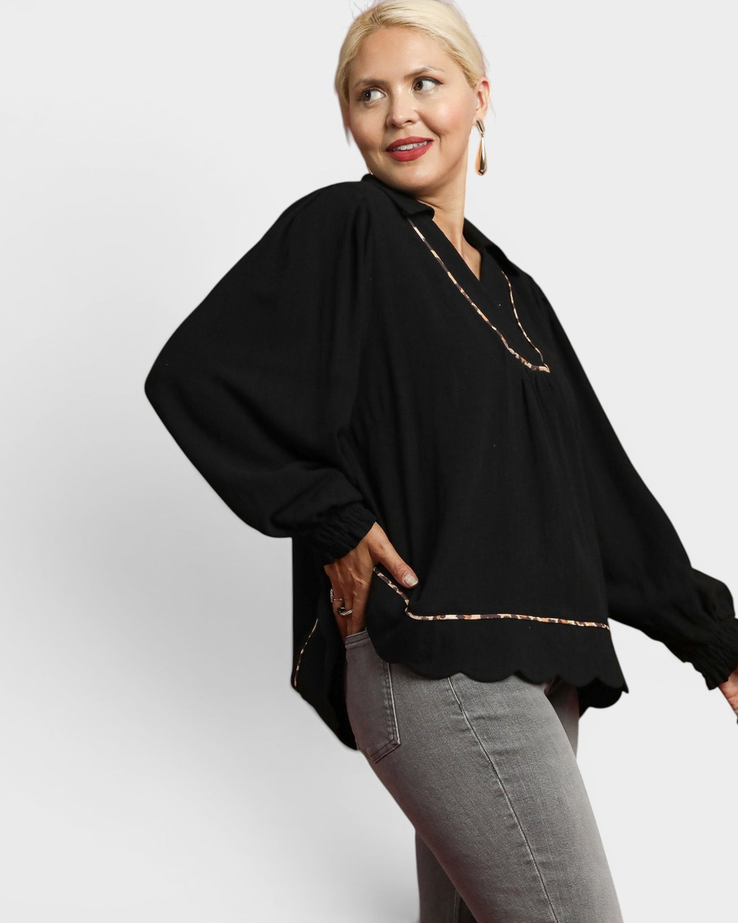 Woman wearing a black blouse with a white background