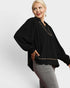 Woman wearing a black blouse with a white background