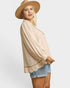 Woman wearing a beige top, denim shorts, and a beige hat on a white background