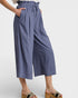 Blue wide-leg pants worn by a person on a white background