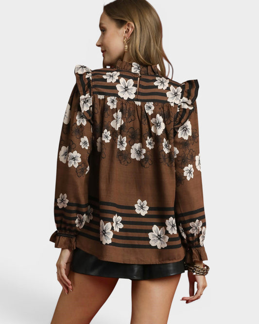 Woman wearing a brown floral blouse with a white background