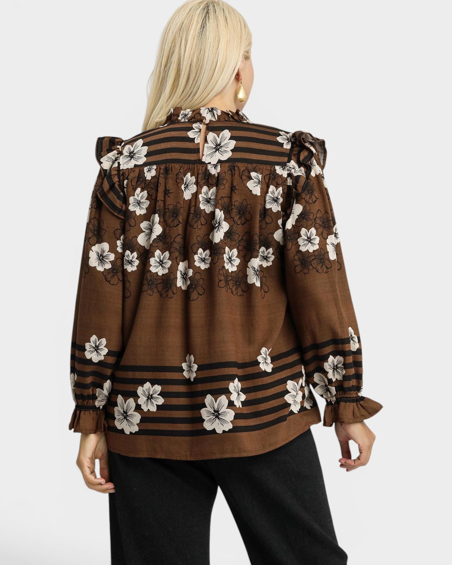 Brown blouse with floral patterns on a white background