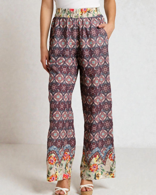 Woman wearing patterned pants on a plain background