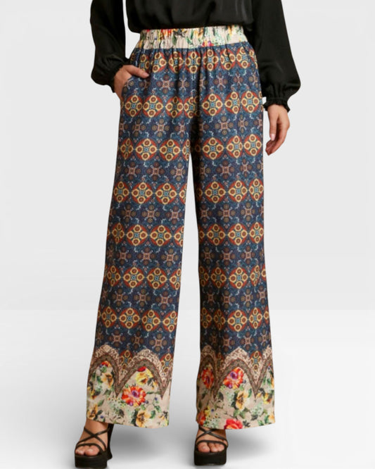 Colorful patterned pants worn by a person on a white background