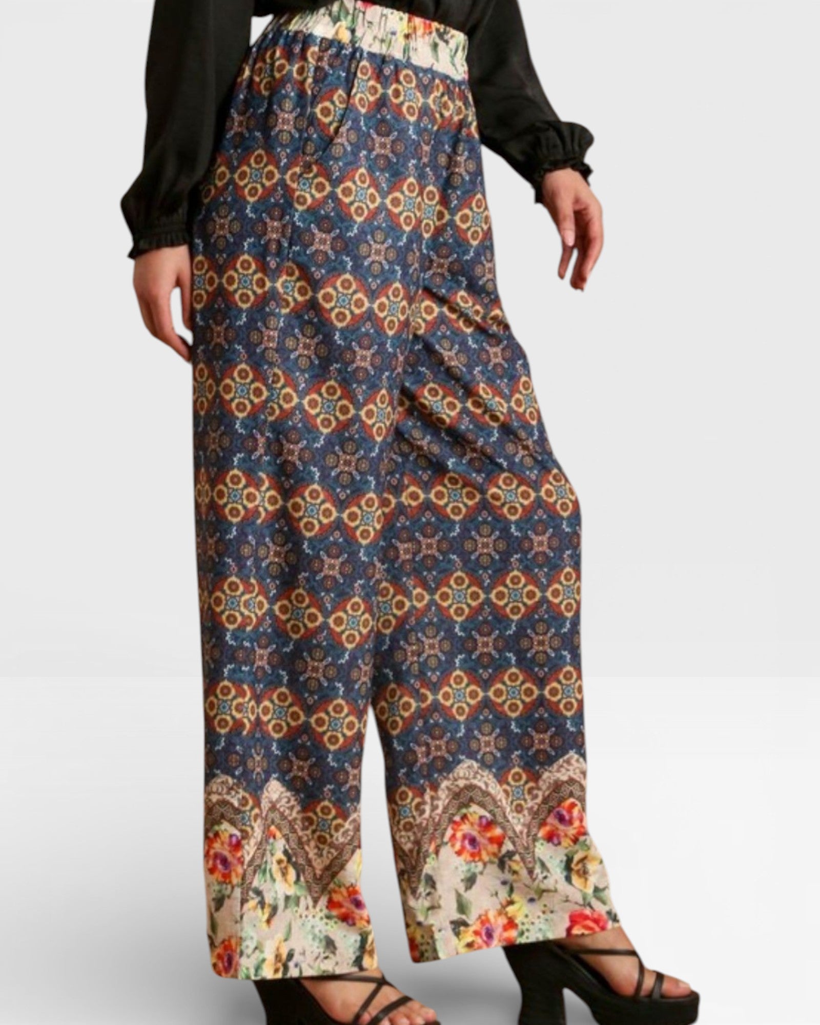 Colorful patterned pants worn by a person on a white background
