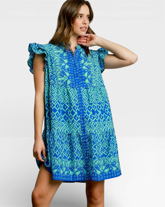 Woman wearing a blue patterned dress on a white background