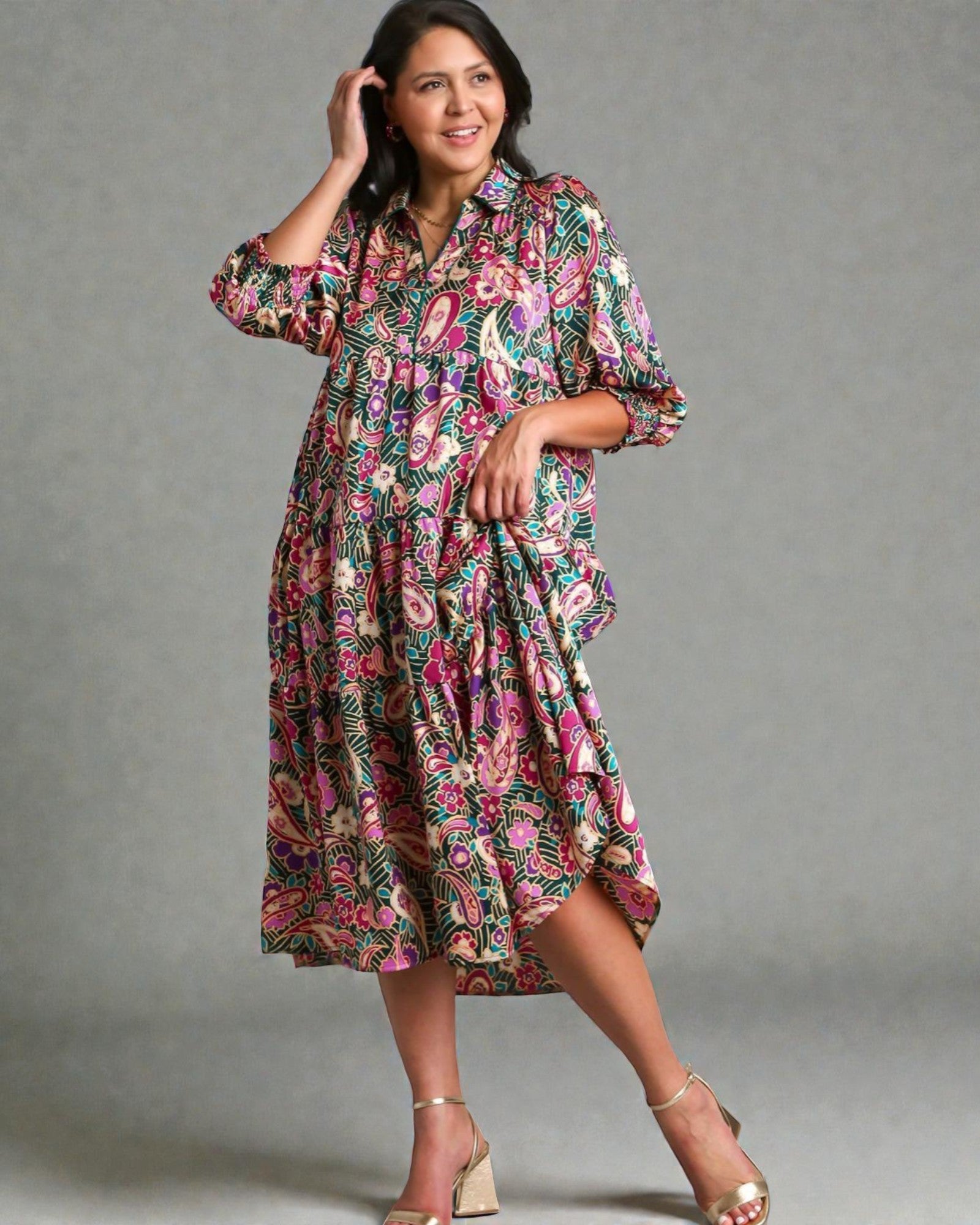 Woman wearing a floral dress against a gray background
