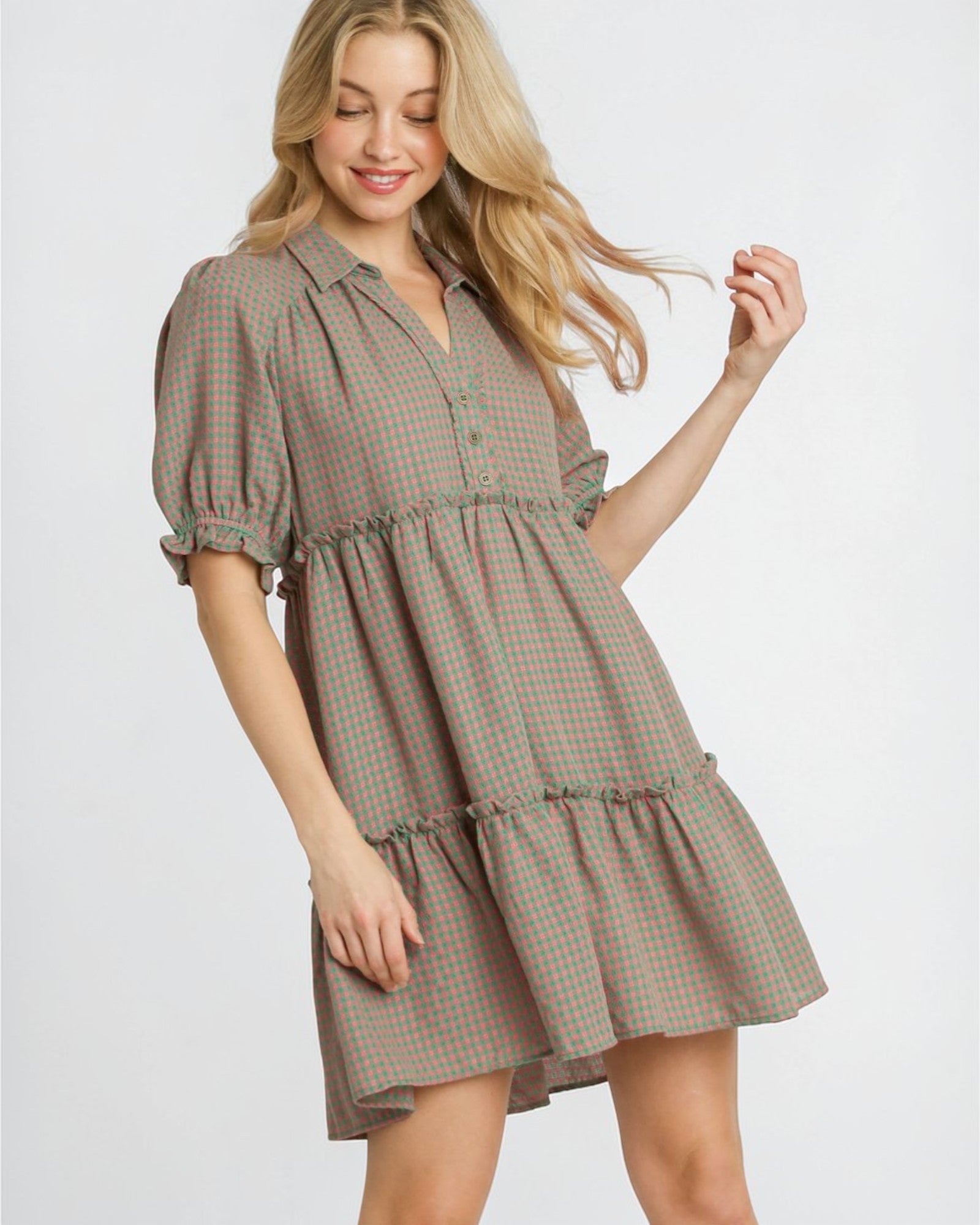 Woman wearing a plaid dress on a white background