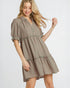 Woman wearing a plaid dress on a white background