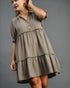 Woman wearing a patterned dress against a gray background