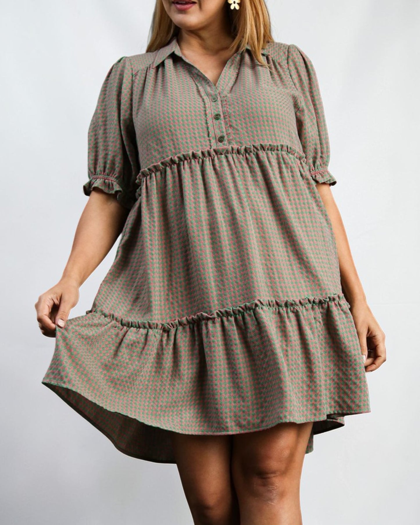 Woman wearing a plaid dress with a plain background