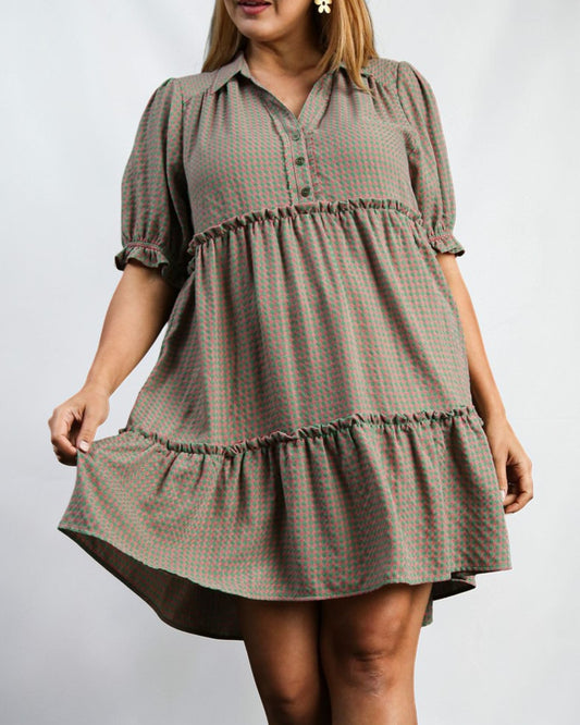 Woman wearing a plaid dress with a plain background