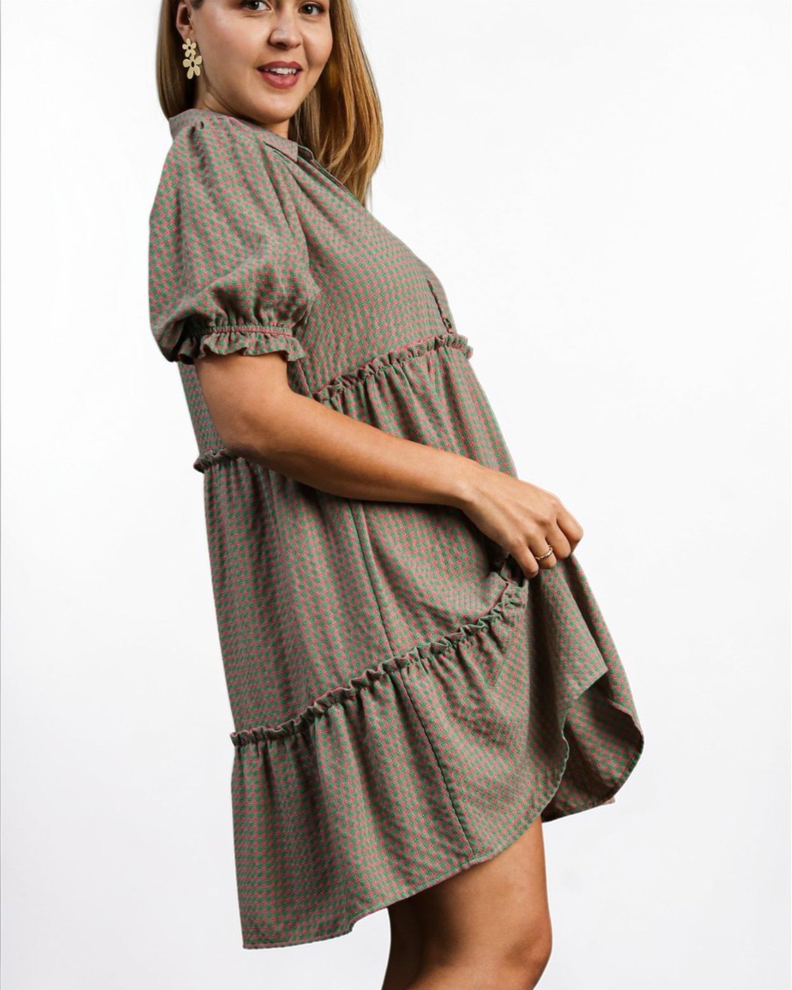 Woman wearing a plaid dress on a white background