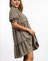 Woman wearing a plaid dress on a white background