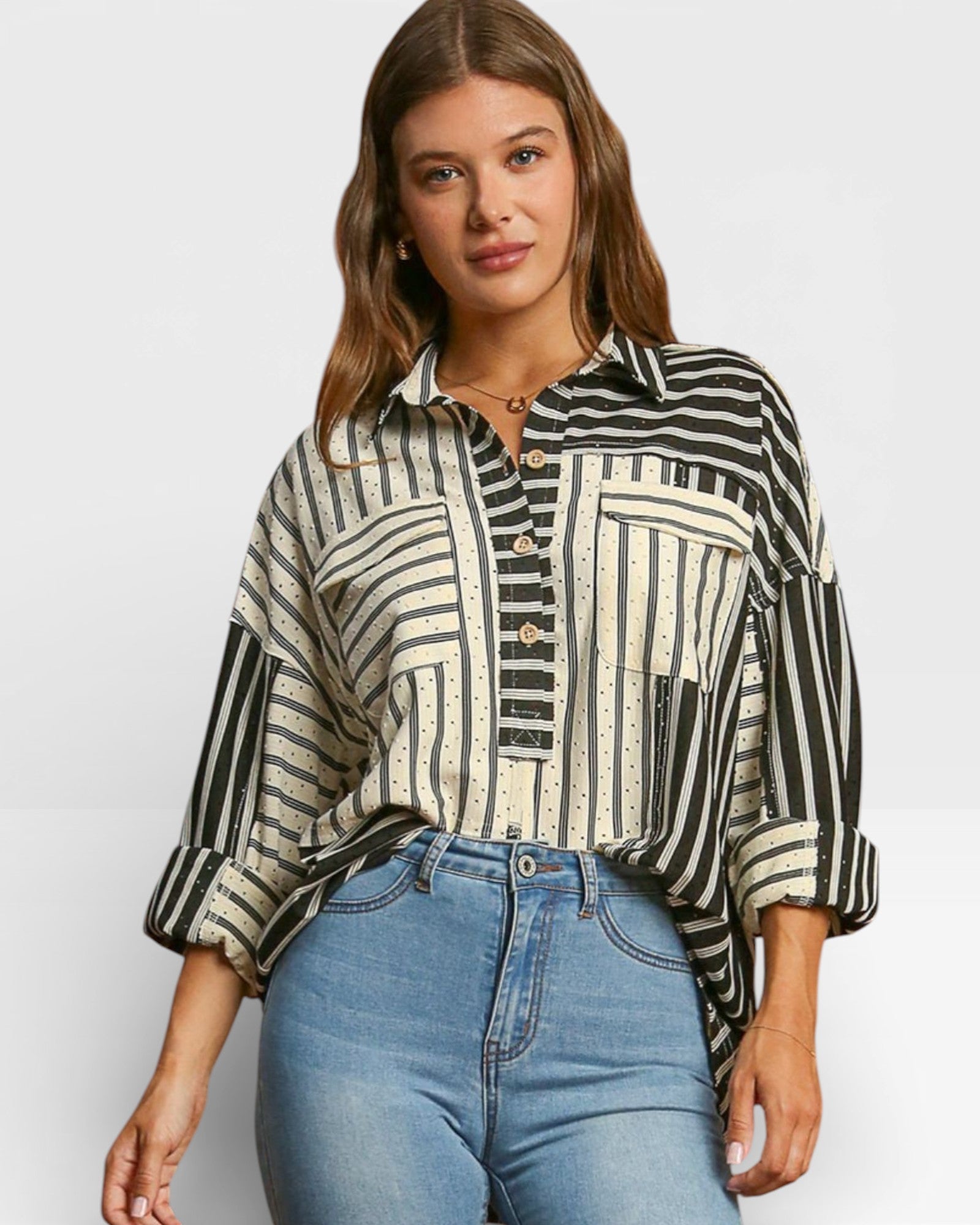 Woman wearing a black and white striped shirt with a plain background