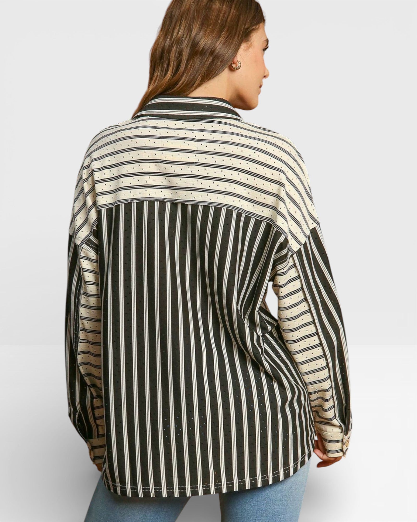 Person wearing a black and beige striped shirt on a white background