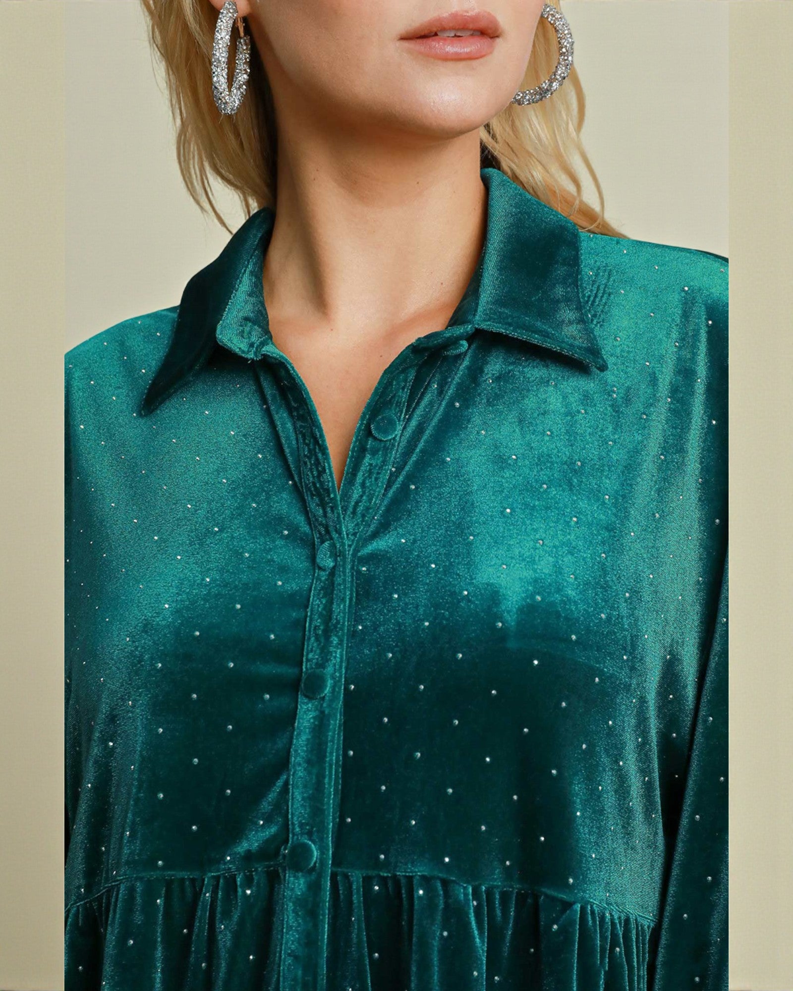 Teal velvet dress with rhinestone embellishments on a neutral background