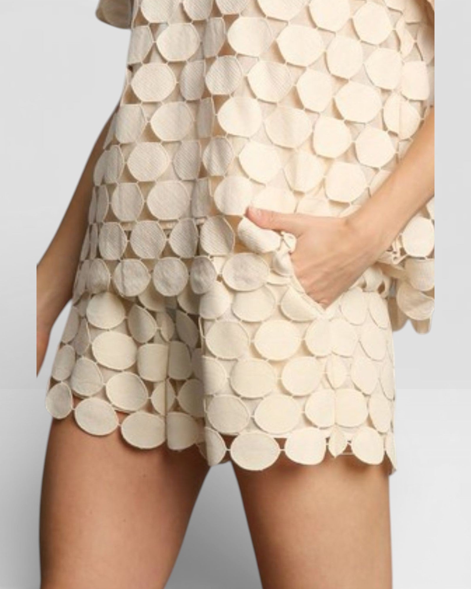 Beige dress with circular pattern on a plain background