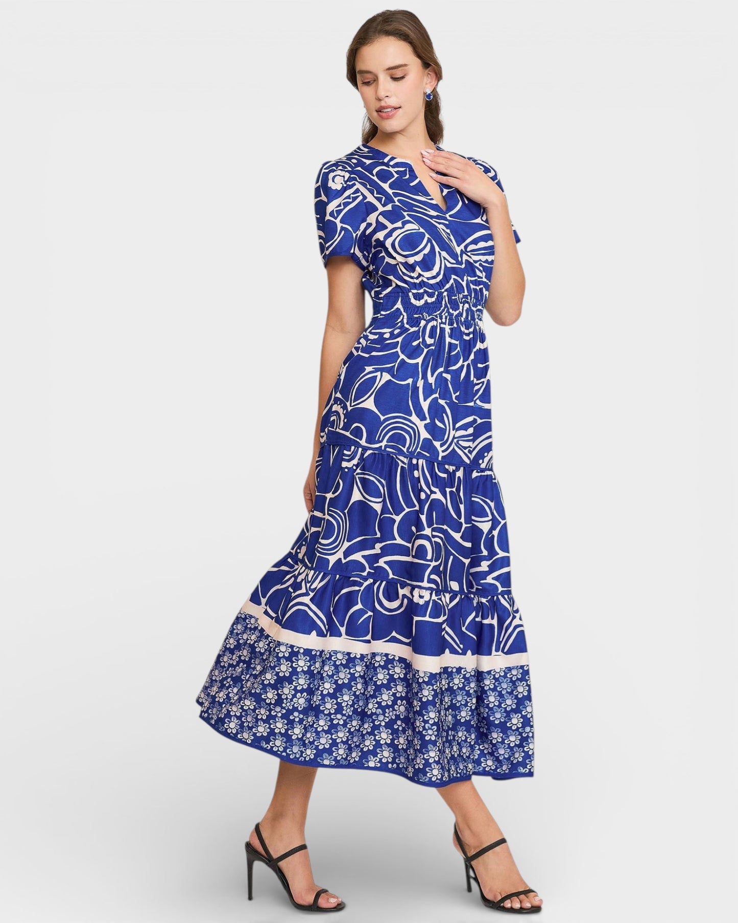 Woman wearing a blue patterned dress on a white background