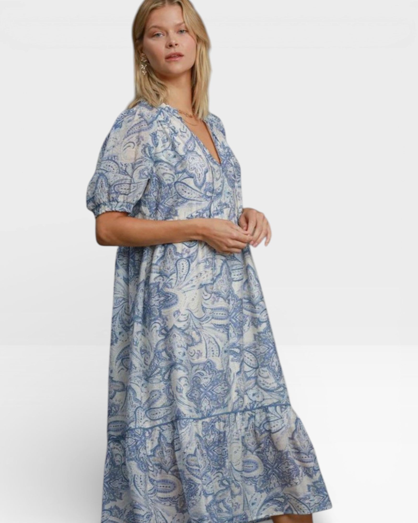 Woman wearing a blue floral dress on a white background