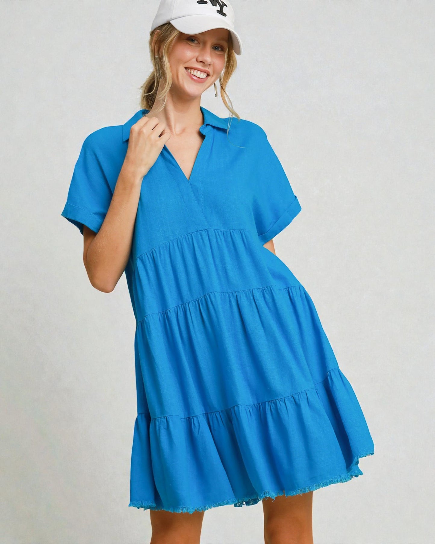 Woman wearing a blue dress with a white background