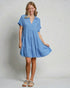 Woman wearing a blue dress against a plain background