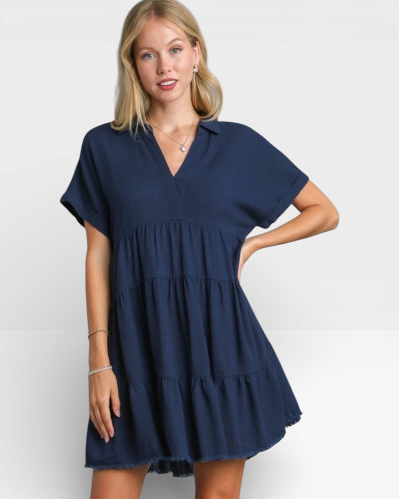 Woman wearing a navy blue dress on a white background