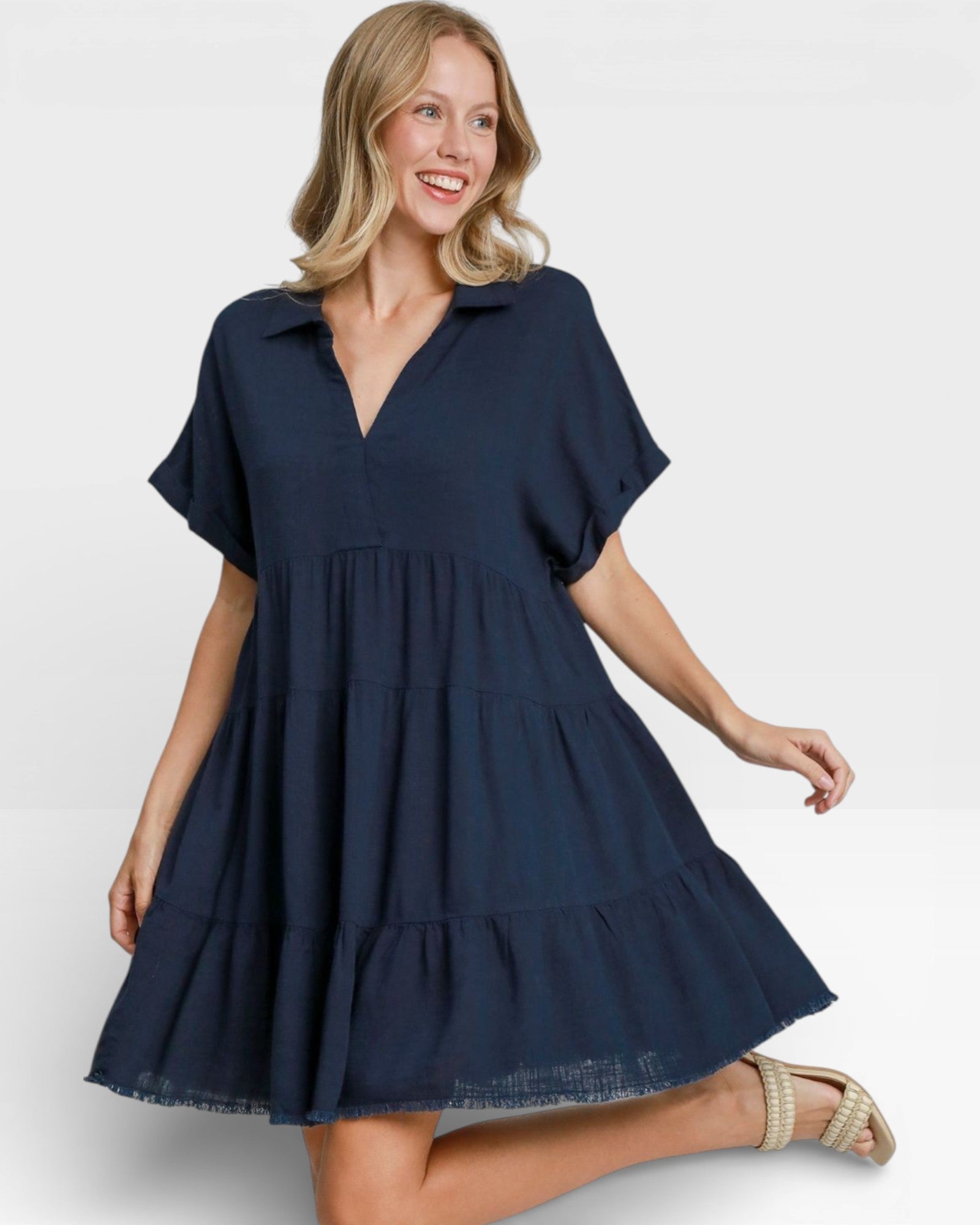 Woman wearing a navy blue dress on a white background