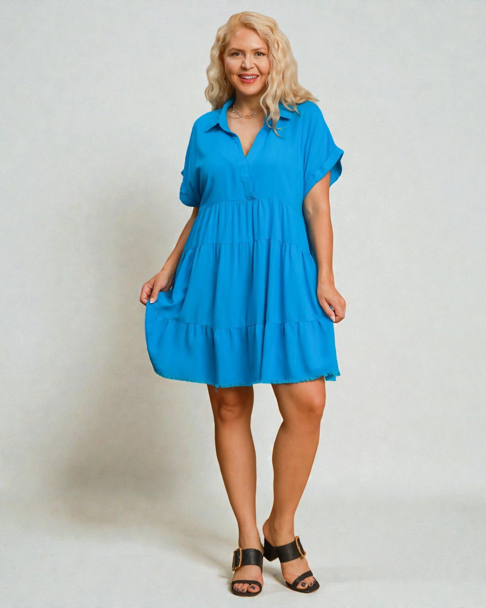Woman wearing a blue dress against a plain background