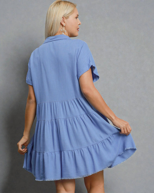 Woman wearing a blue dress against a gray background