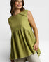 Woman wearing a green sleeveless top with ruffled details on a white background