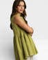 Woman wearing a green sleeveless dress on a white background