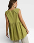 Woman wearing a green sleeveless top with ruffled neckline on a white background