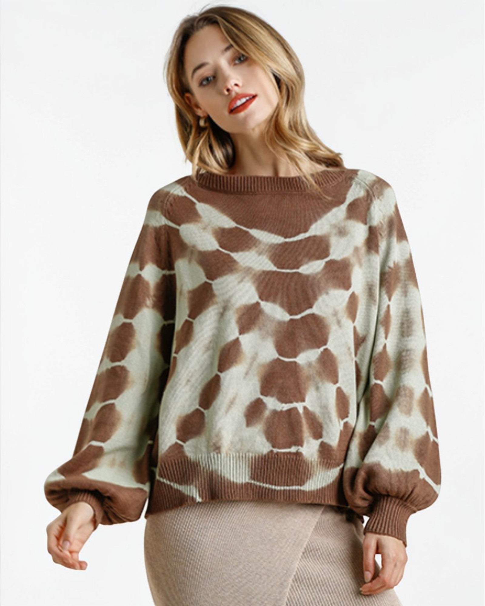 Woman wearing a brown and beige patterned sweater on a white background