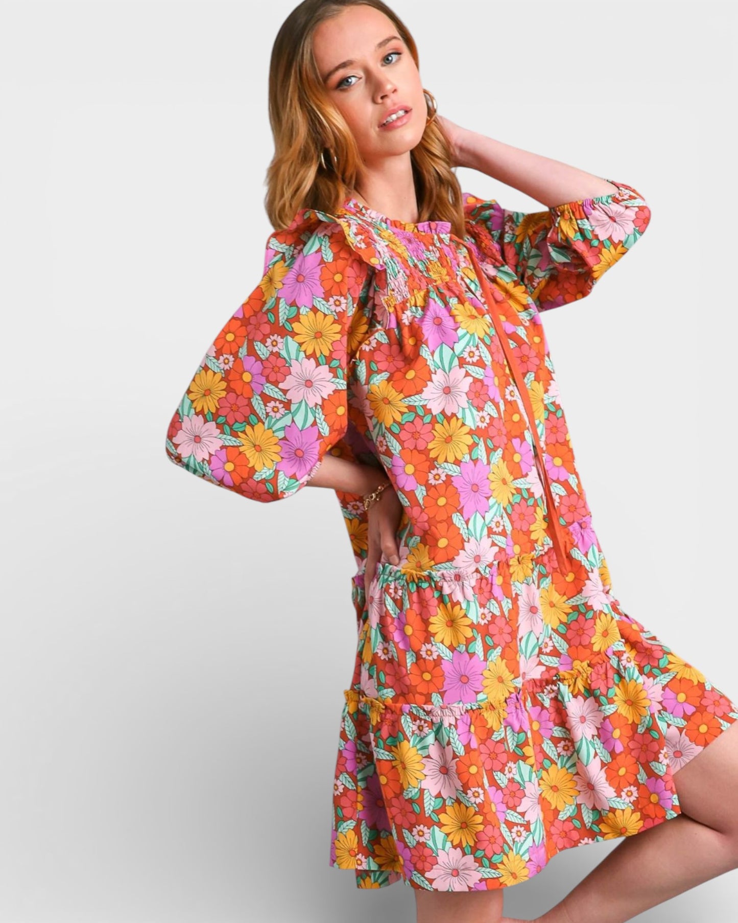 Woman wearing a colorful floral dress on a white background