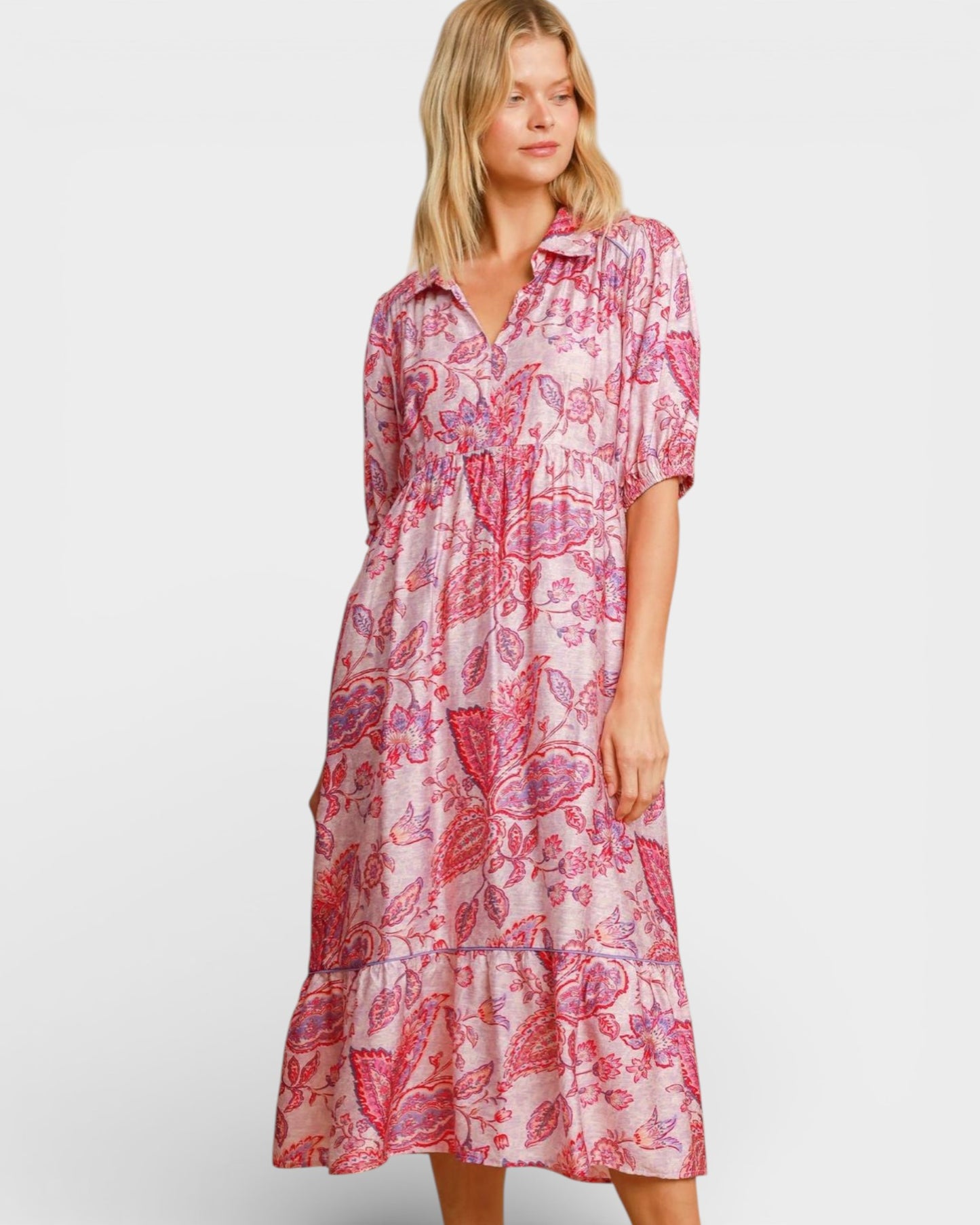 Woman wearing a pink floral dress on a white background