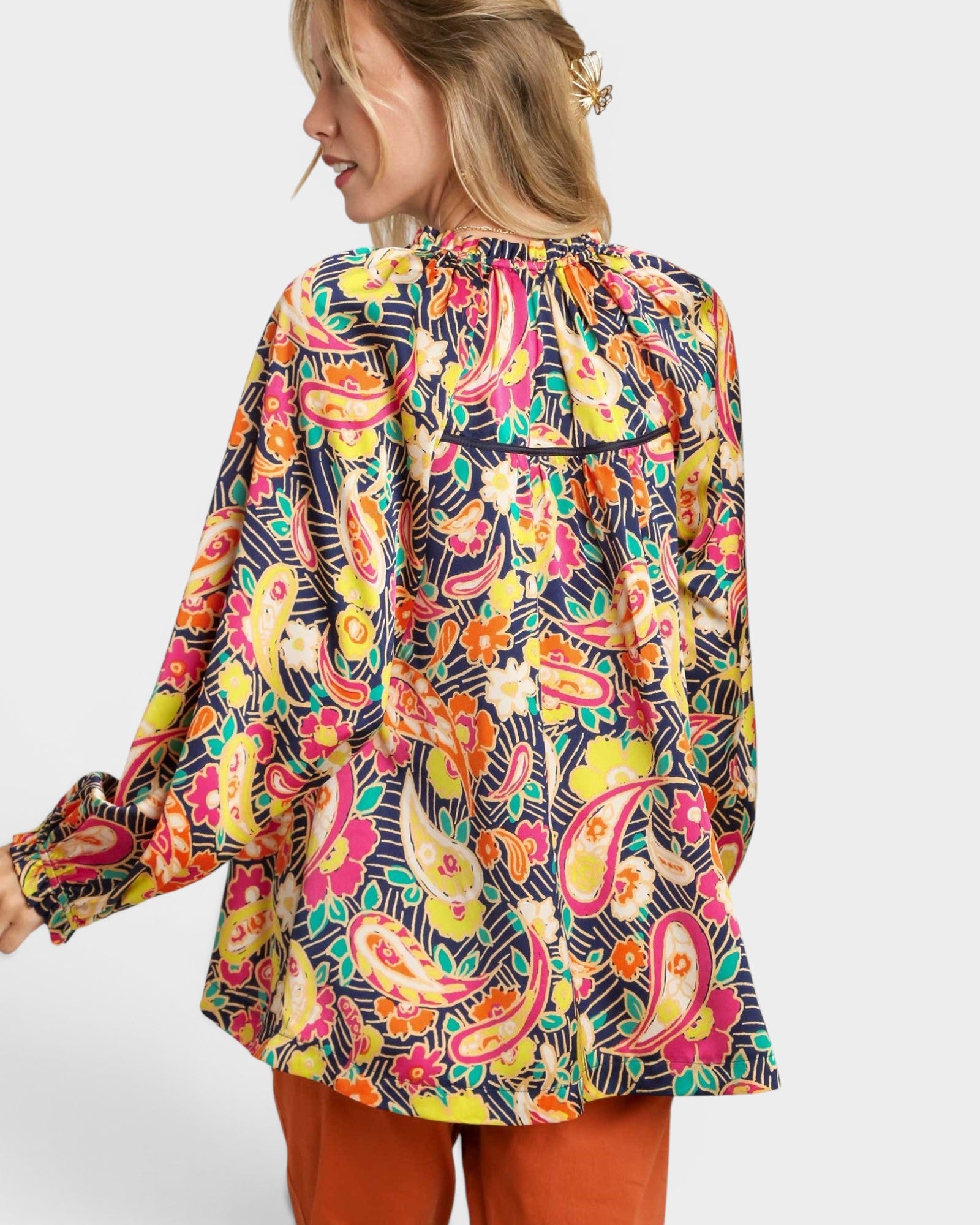 Woman wearing a colorful patterned shirt on a white background