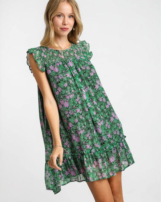 Woman wearing a green floral dress on a white background