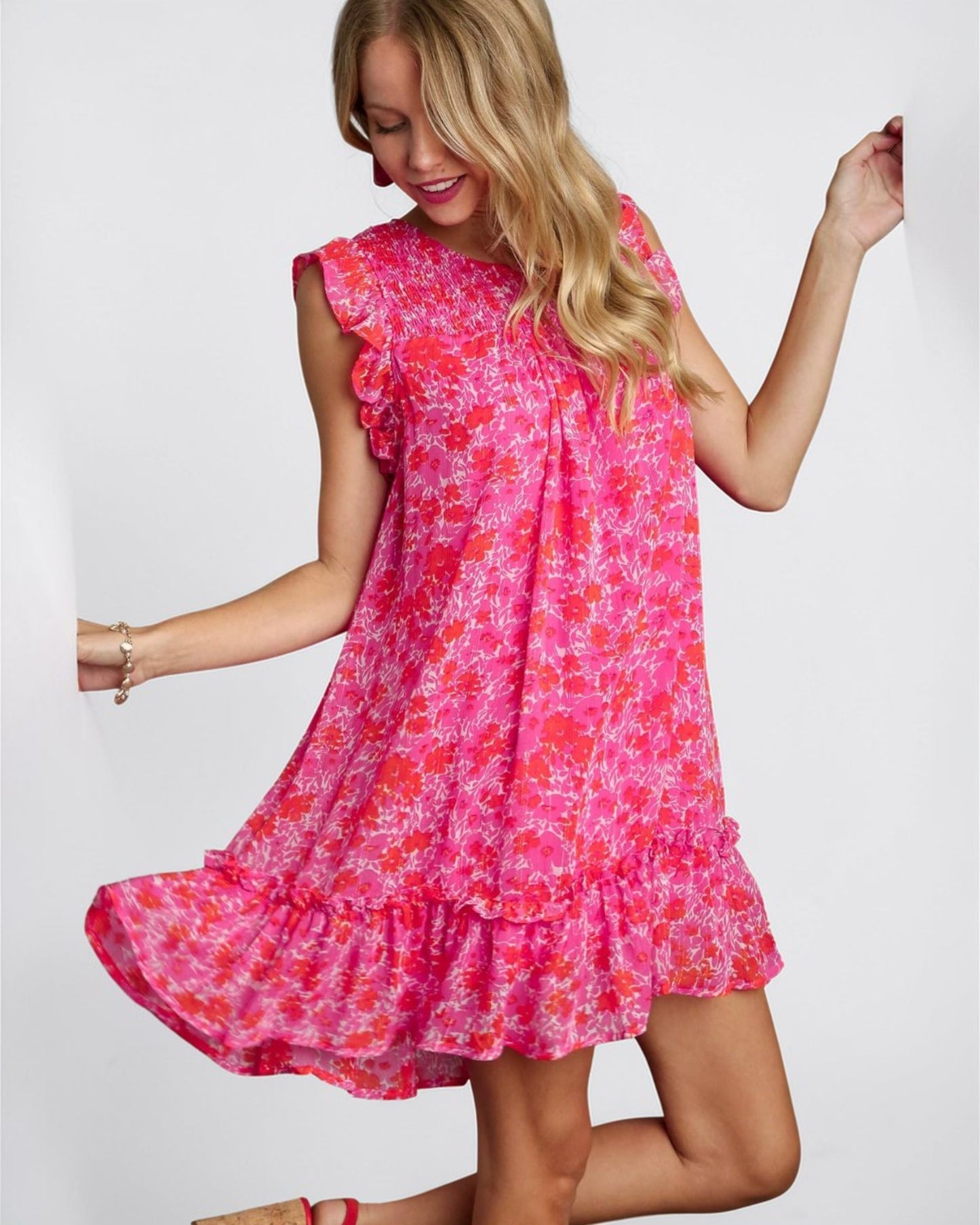 Woman wearing a pink floral dress on a white background
